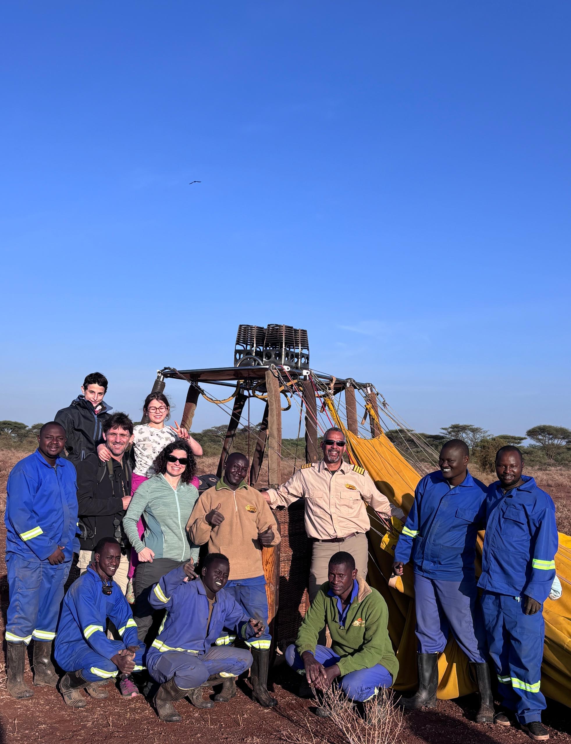 Guests discussing balloon safari plans with a guide at a lodge