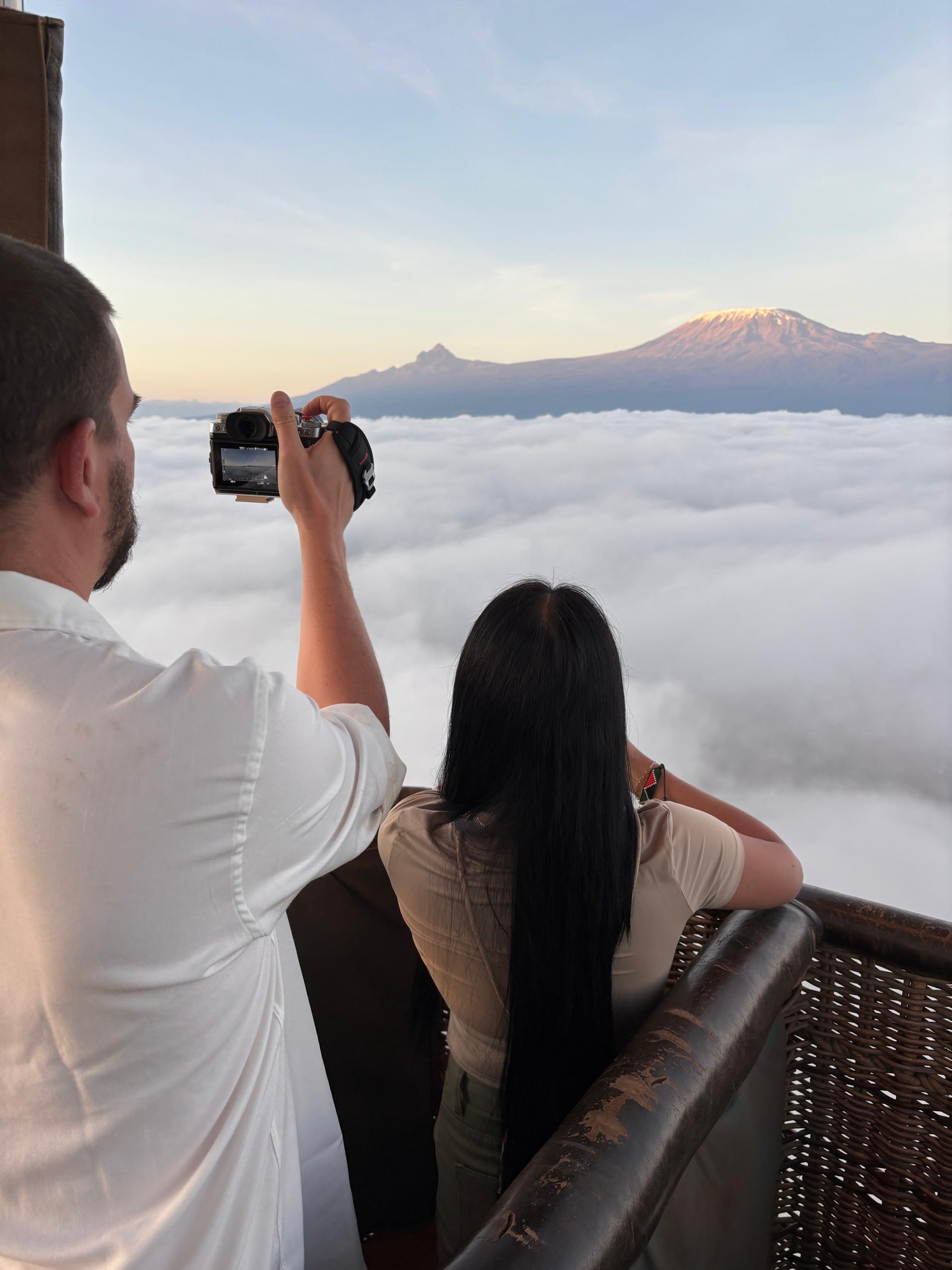 Guests enjoying breakfast at the Kenya Balloon Safaris pavilion with Mount Kilimanjaro in the background