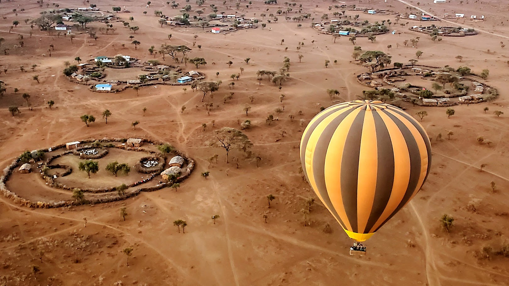 Hot air balloon floating over Amboseli at sunrise